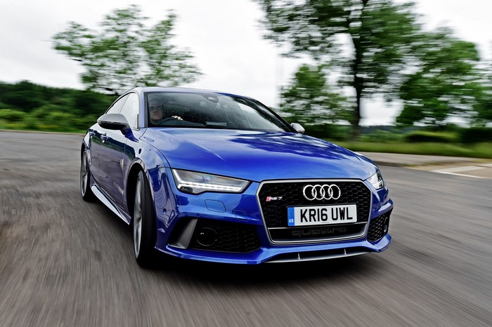 Blue Audi RS 7 driving on a road