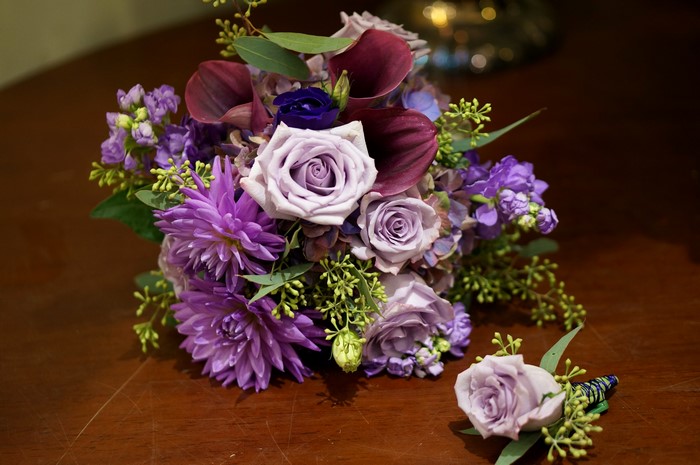Purple and burgundy floral bouquet with boutonniere