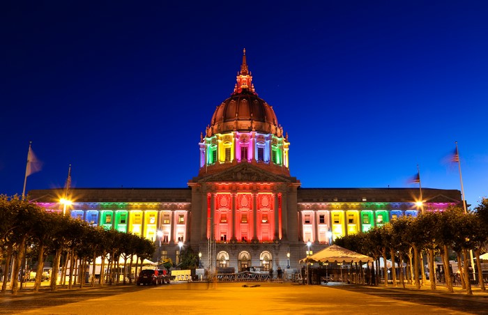 San Francisco City Hall lit with rainbow colors at night