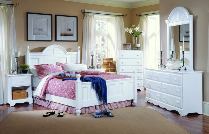 White bedroom set with bed, dresser, and nightstand