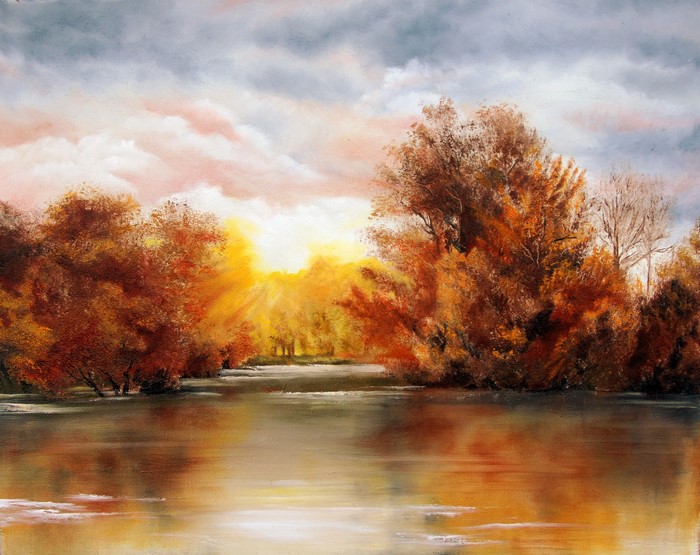 Autumn trees reflected in a river at sunset