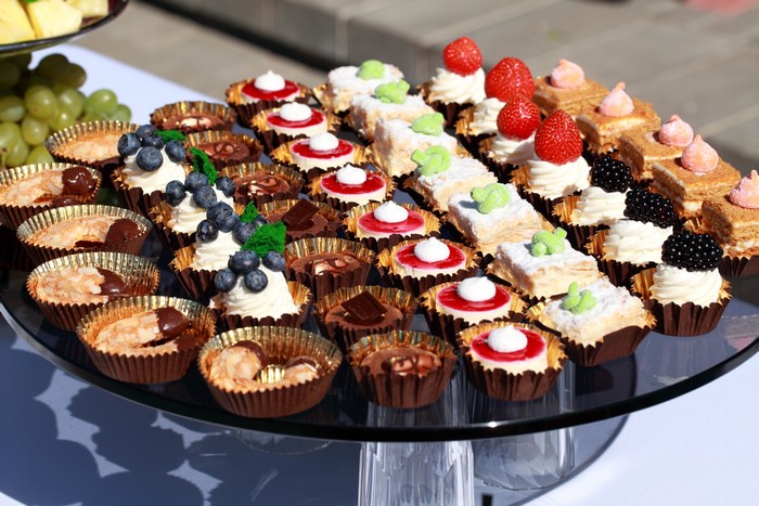 Many little cakes and sweets on a platter