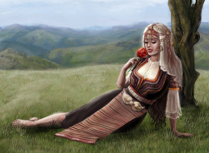 Woman in traditional dress holding a rose in a grassy field
