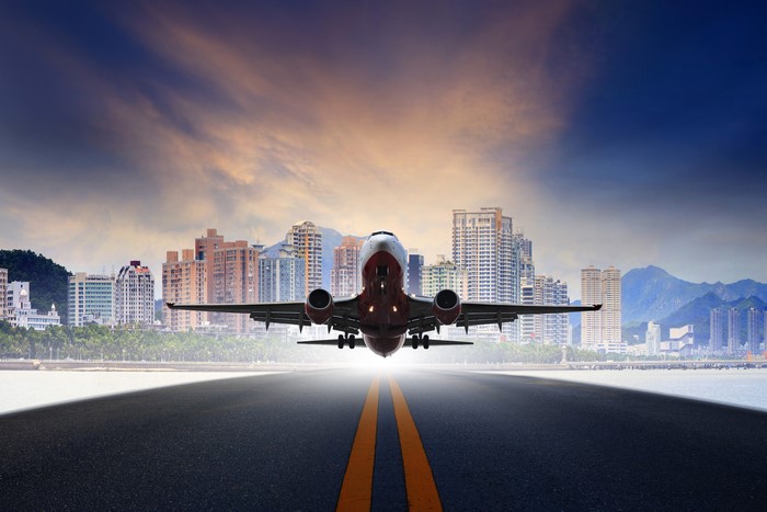 Airplane taking off over a city skyline