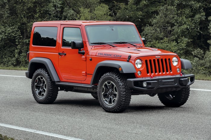 Orange Jeep Wrangler Rubicon parked on a road