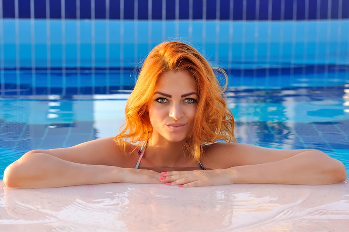 Redhead girl in a pool