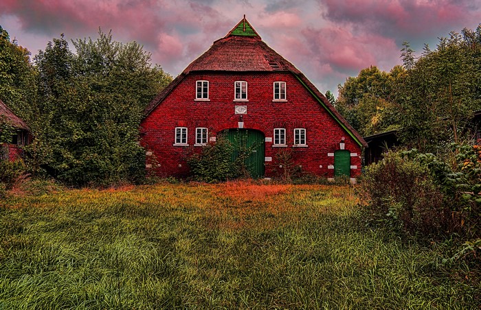 Red brick barn with thatched roof in Germany
