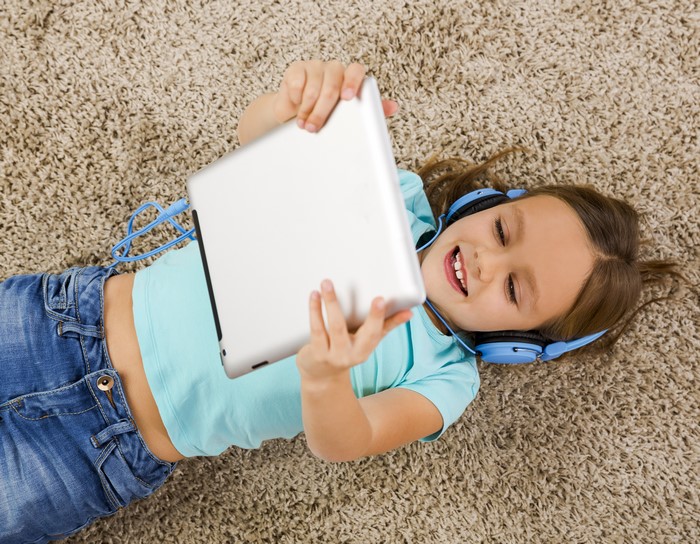 Girl with headphones using a tablet
