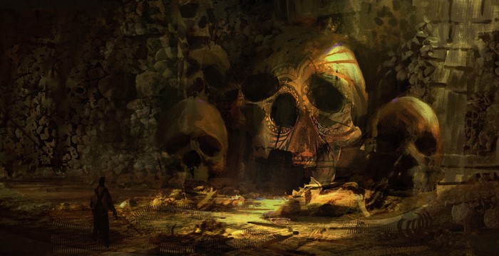 Giant skulls in a dark cave with a lone figure