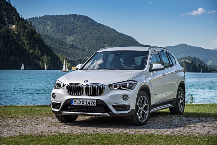 White BMW X1 xDrive F48 by a Lake