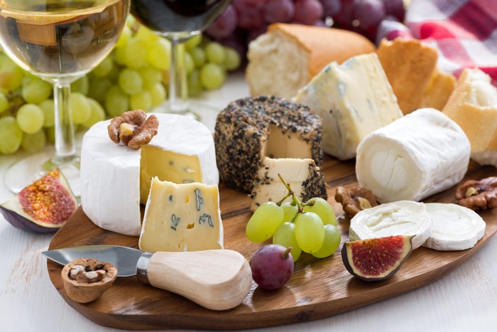 Cheese board with grapes, figs, and nuts