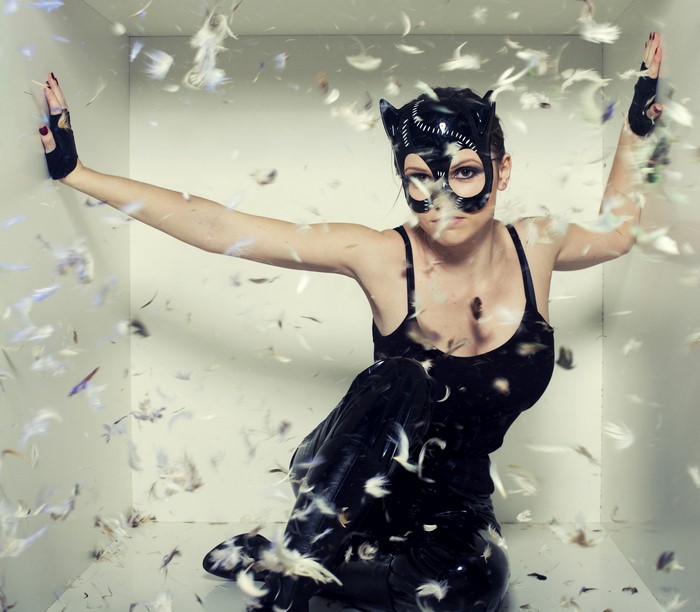 Woman in cat mask with feathers