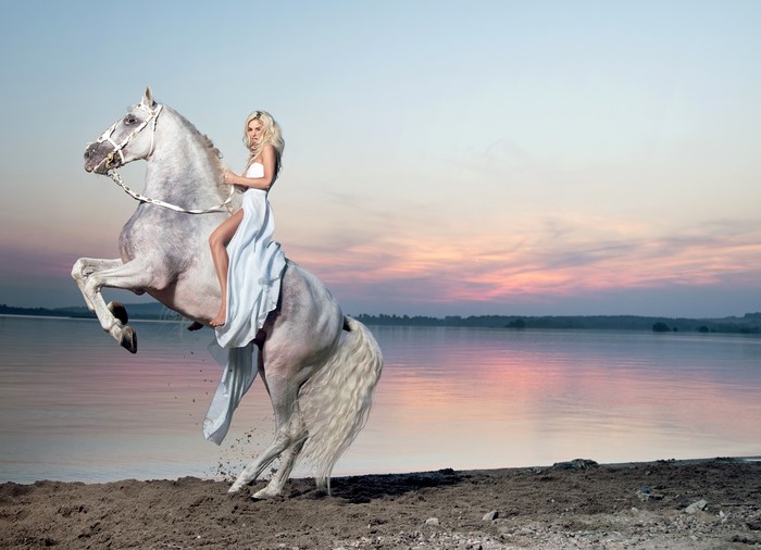 Blonde Woman on Rearing White Horse by the Coast