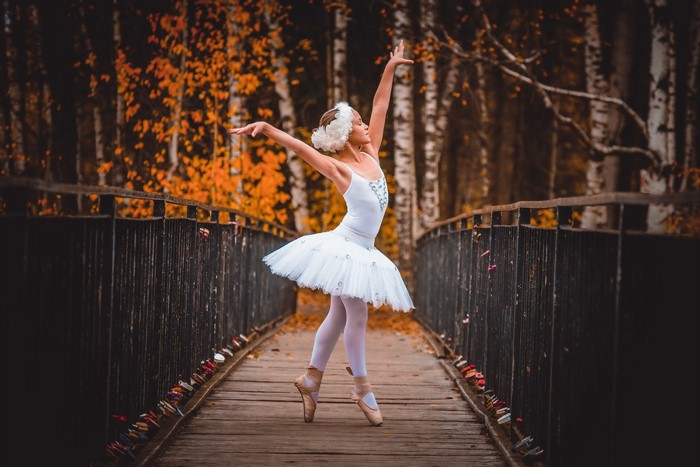 Ballerina on a bridge in autumn