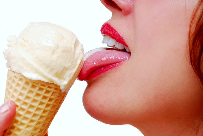Woman licking ice cream cone