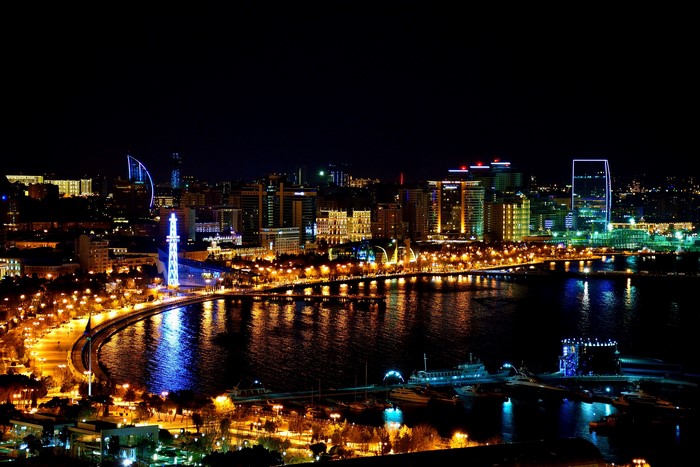 Baku Azerbaijan cityscape at night with illuminated buildings