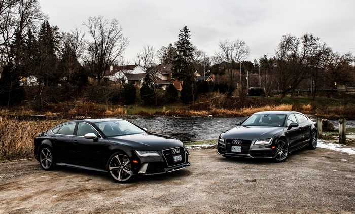 Two Audi RS7 cars by a river