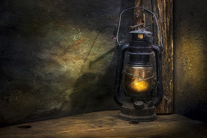 Old kerosene lamp on a wooden surface