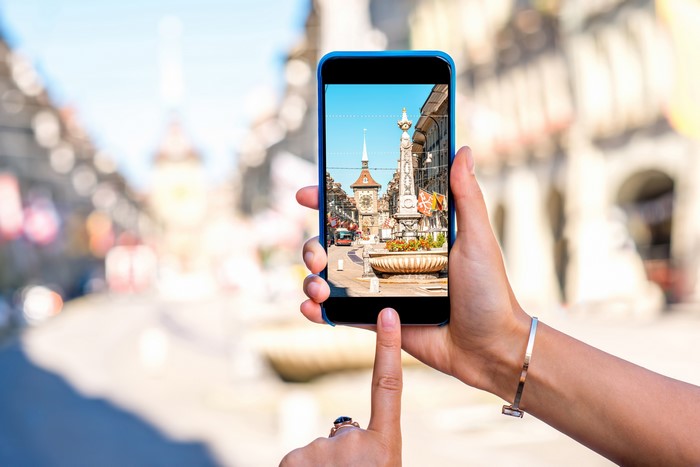 Person taking a photo of Bern, Switzerland with a smartphone