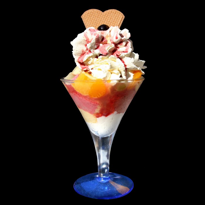 Ice cream sundae with fruit and whipped cream