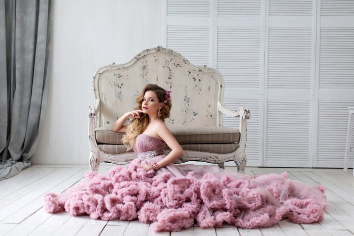 Woman in a pink dress sitting on the floor
