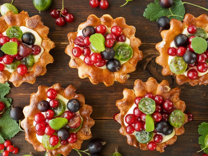 Berry tarts with cream and fresh berries