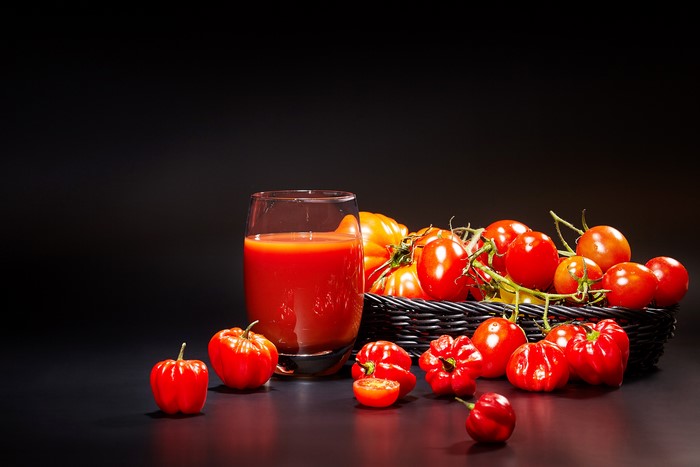Tomatoes and tomato juice in a glass and basket