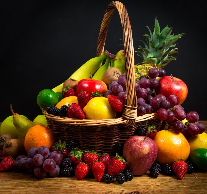 Fruit basket with apples, grapes, strawberries, and more