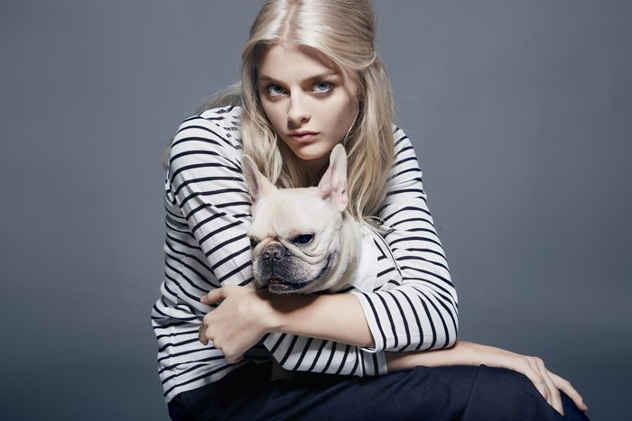 Blonde girl holding a French Bulldog