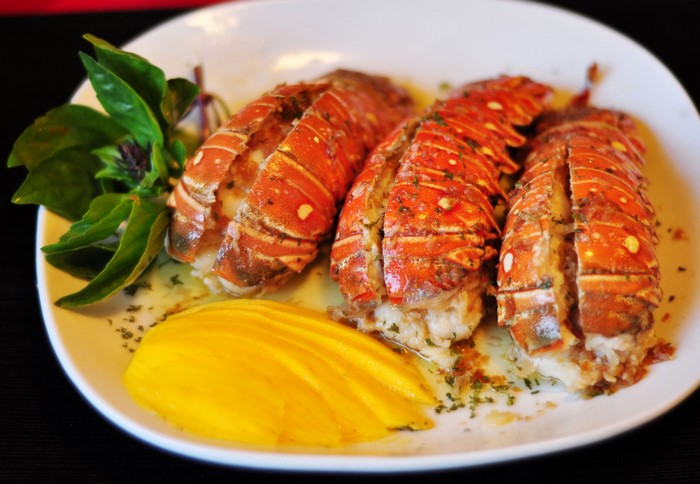 Lobster tails with mango and basil on a plate