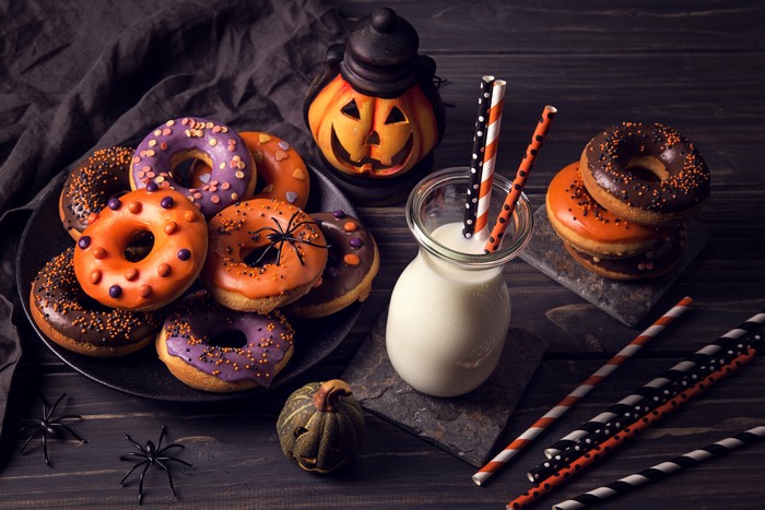 Halloween donuts and milk with pumpkin decoration