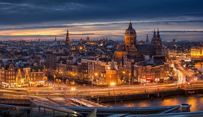 Amsterdam cityscape at night with canals and traffic