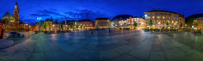 Town square at dusk with church and buildings in Bolzano, Italy