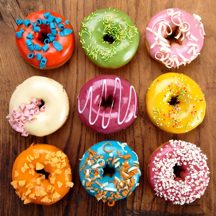 Assortment of colorful donuts on a wooden table