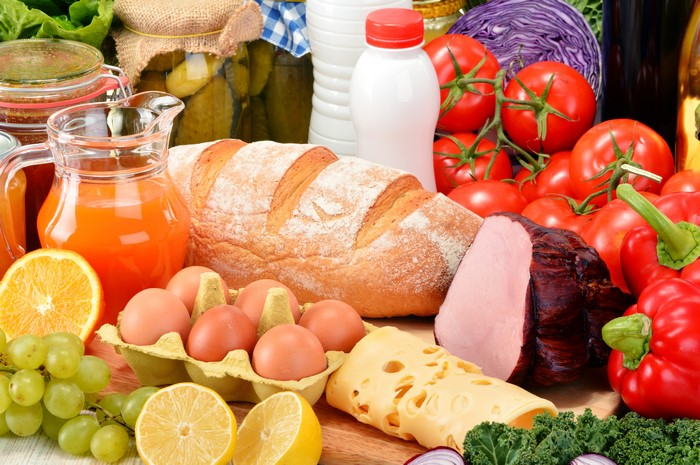 Still-life of bread, cheese, juice, ham, vegetables, fruit, and eggs