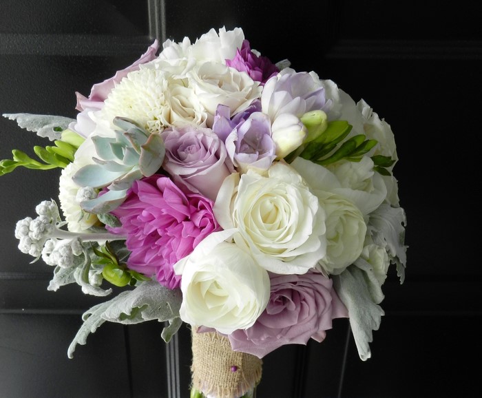 Wedding bouquet with roses, dahlias, succulents, and freesia