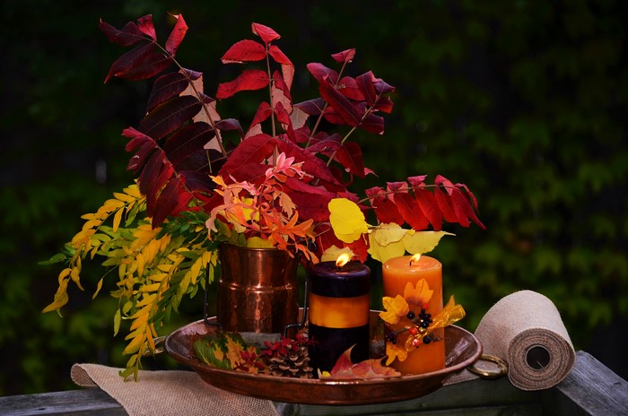 Autumn still-life with candles and foliage