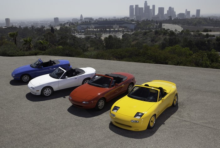Four Mazda MX-5 convertibles with Los Angeles skyline