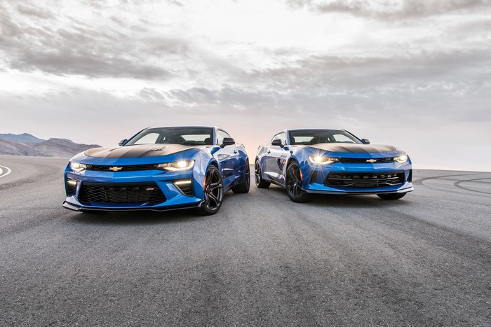 Two blue Chevrolet Camaros on asphalt