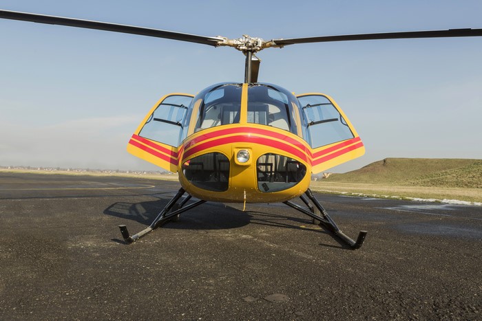 Yellow and red helicopter on tarmac