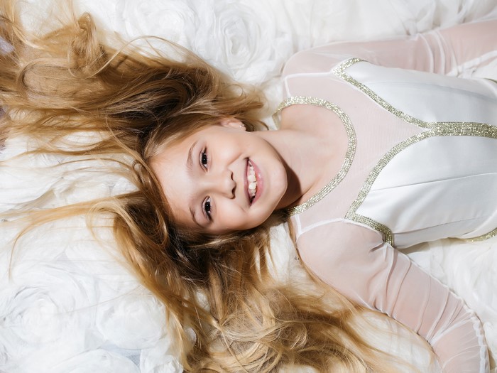 Smiling Brown-Haired Little Girl in White Dress 4K