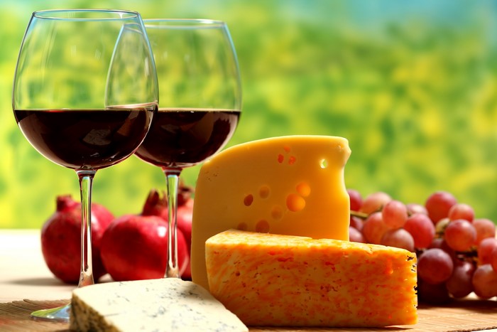 Still-life with cheese, grapes, pomegranates, and red wine