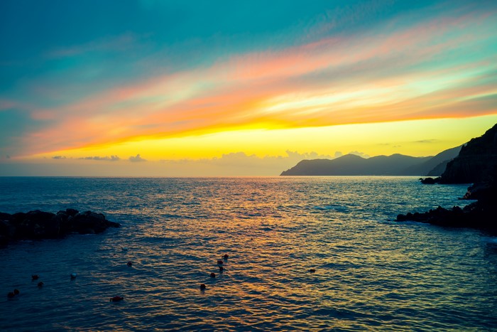 Sunset over the sea with mountains