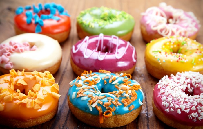 Assortment of colorful donuts with various toppings