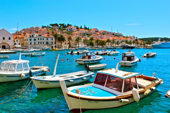 Boats in Hvar, Croatia harbor with town in background