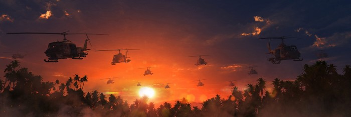 Helicopters flying over a jungle at sunset