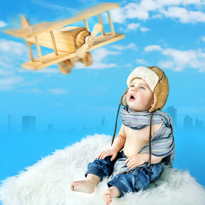 Baby looking at a toy airplane