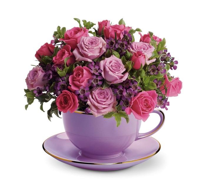 Pink and purple roses in a lavender teacup with saucer
