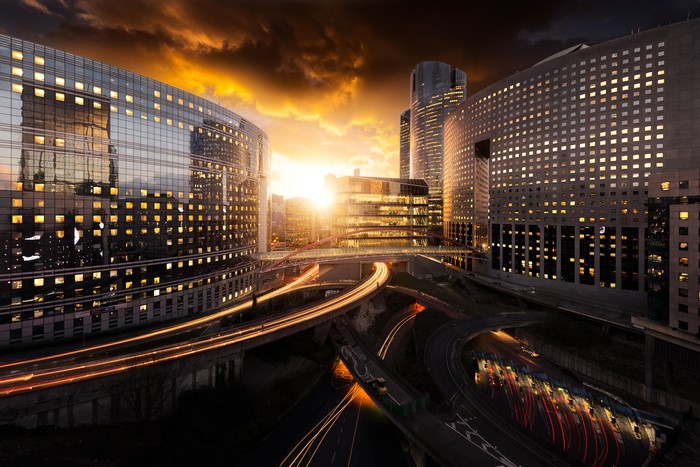 Modern Cityscape with Highways at Sunset