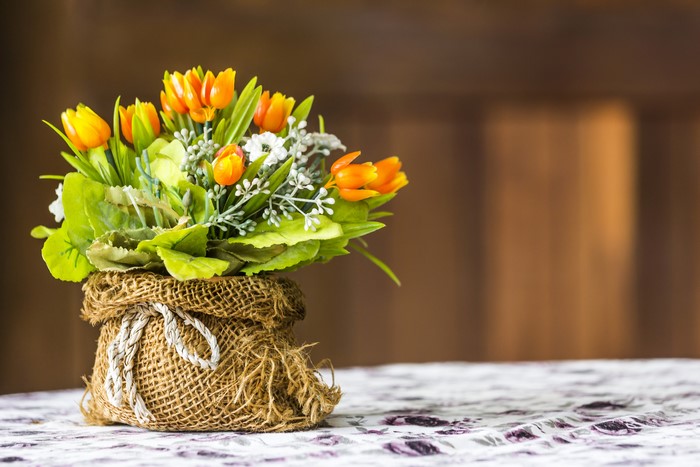 Bouquet of orange tulips in a burlap vase